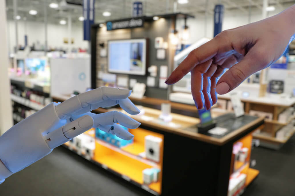 Human hand with robot hand in retail store